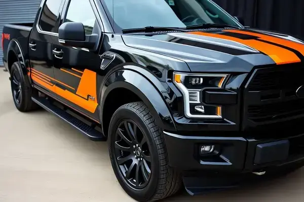 Pickup truck with midnight black and orange racing stripes